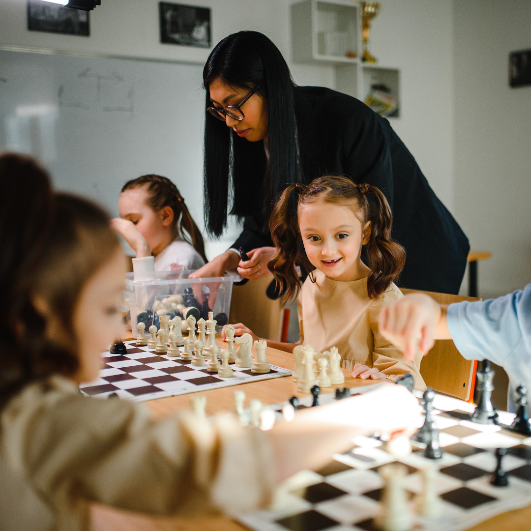 Little Girl Playing Chess with American Chess Academy